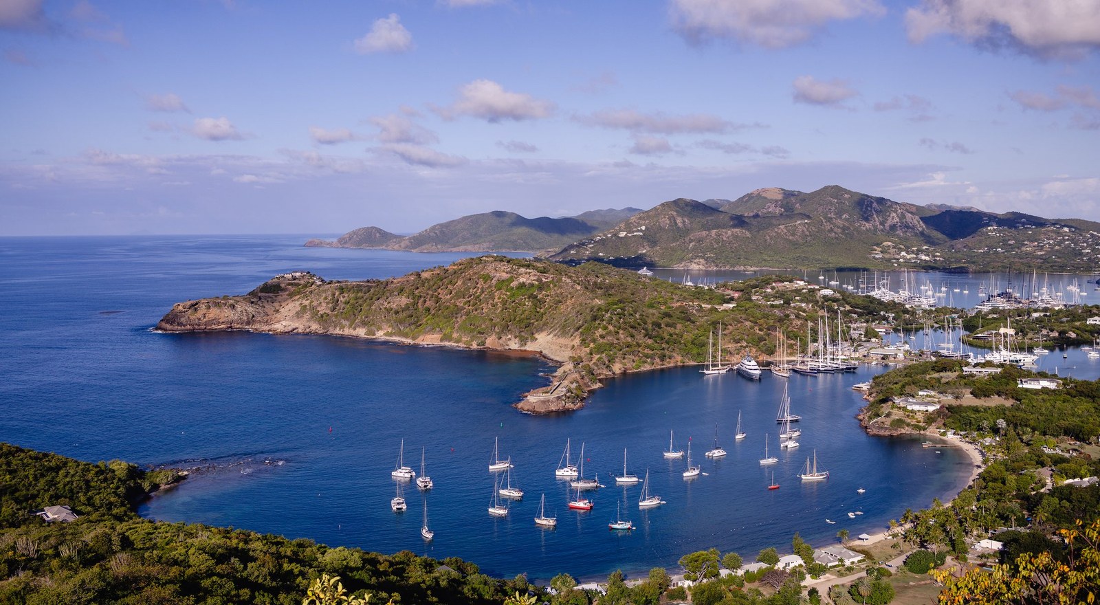 English Harbour in Antigua from the hillside above, yachts moored in the bay, where the crossing finishes