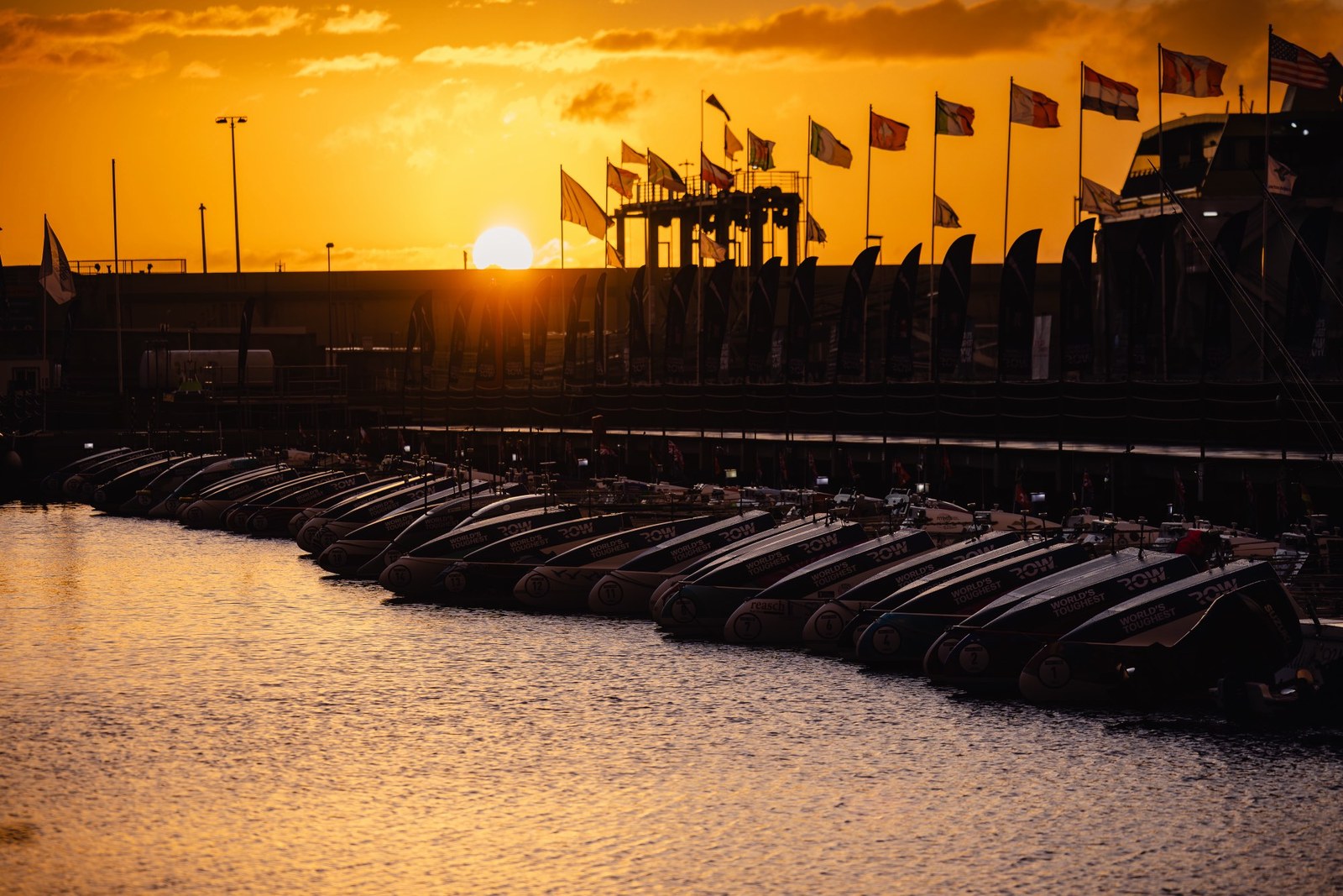 Race flags over the marina at sunset