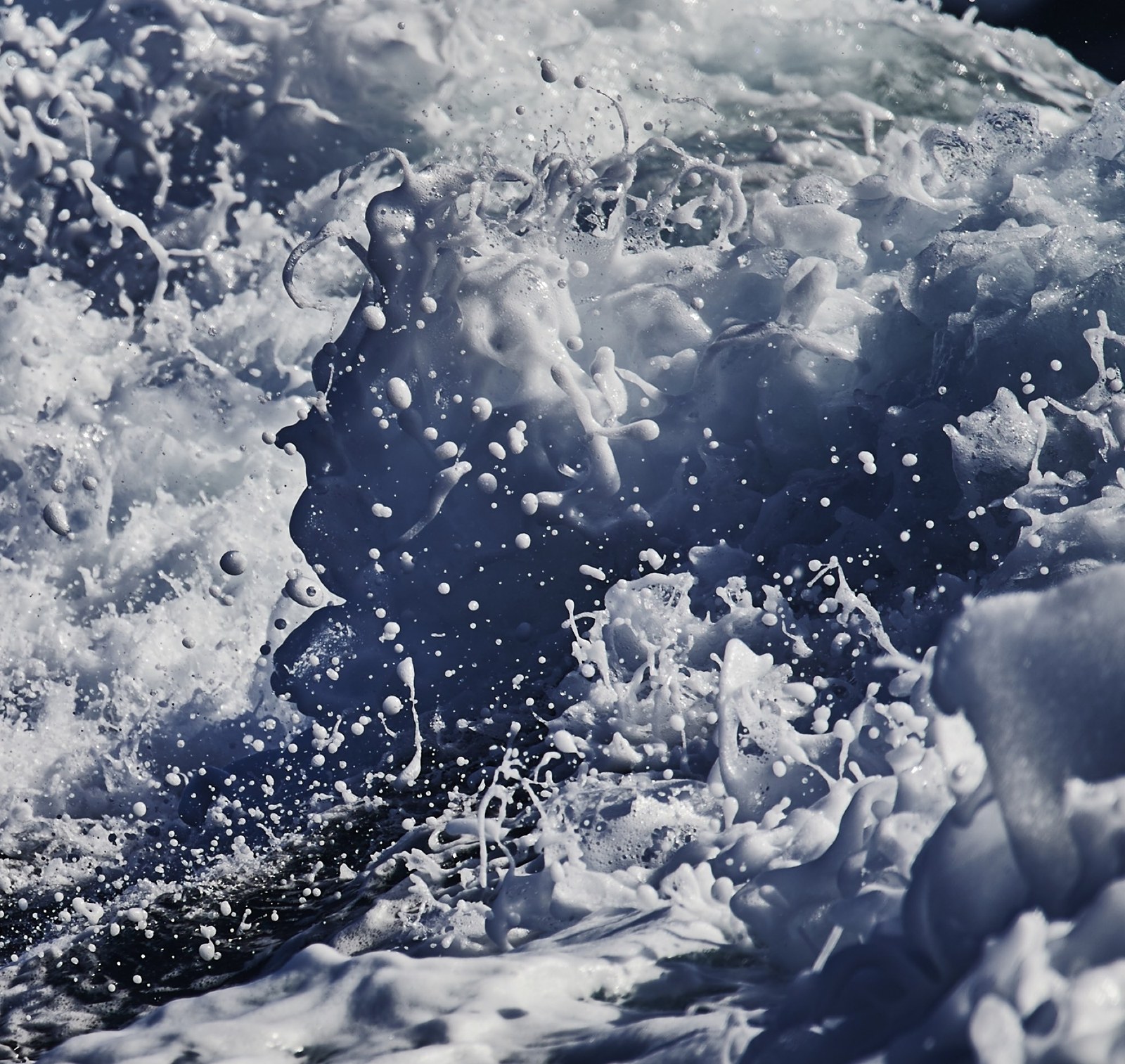 Atlantic swell breaking over the side of a boat